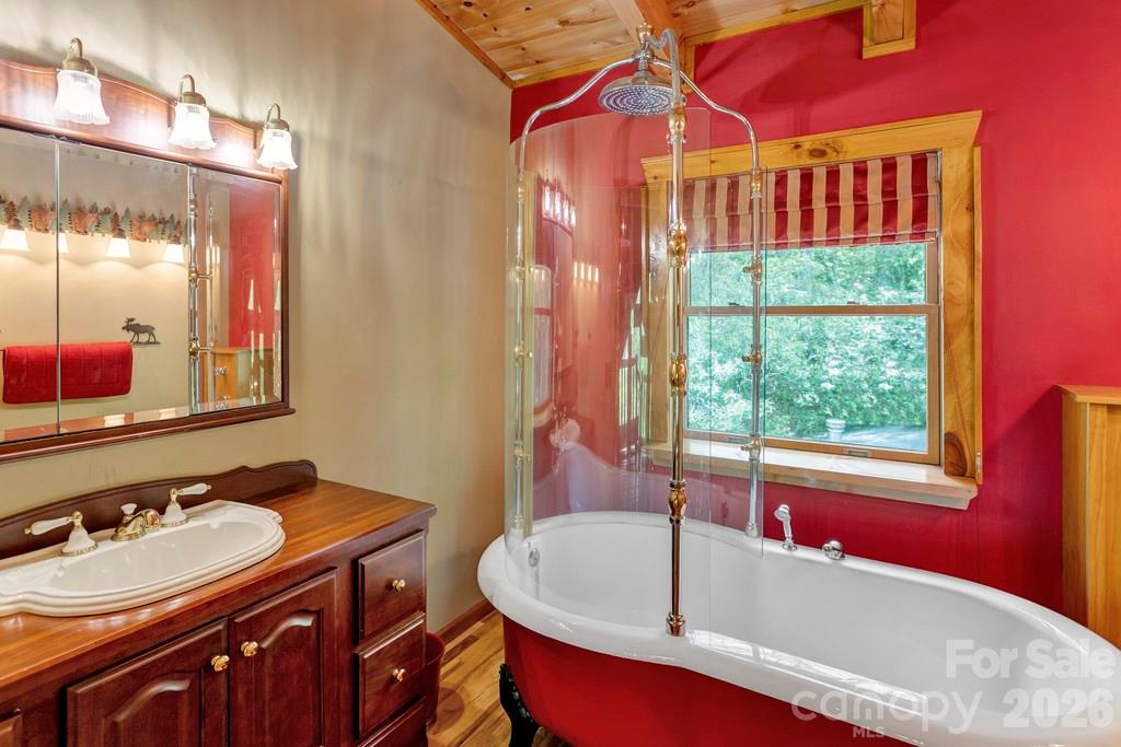 35 Falcon Crest Loop Maggie Valley, NC 28751 - Photo 22 of 46 a bathroom with a tub sink and mirror