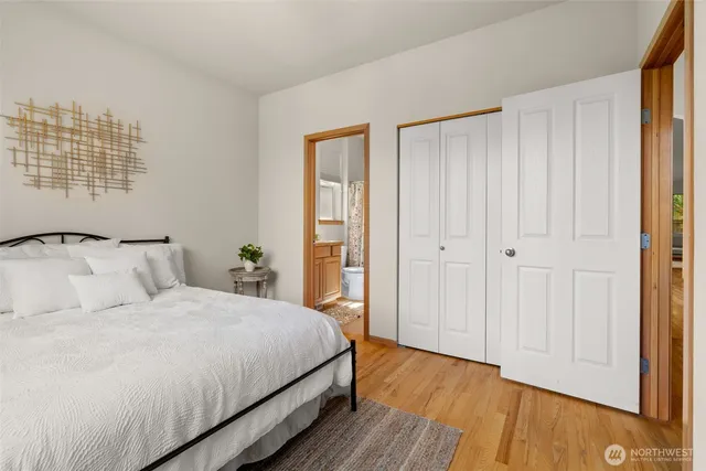 a bedroom with a bed and windows