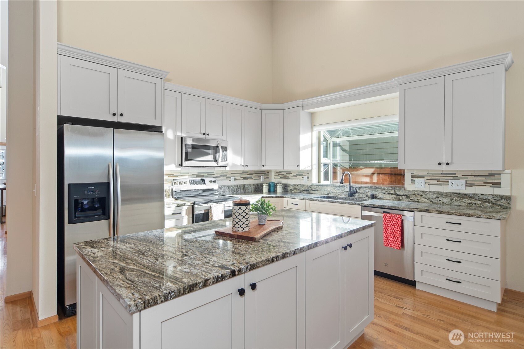 18130 Sunrise Ridge Avenue Northeast Poulsbo, WA 98370 - Photo 12 of 30 a kitchen with granite countertop a sink stove and refrigerator