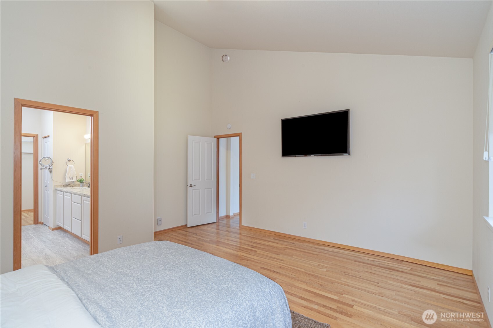 18130 Sunrise Ridge Avenue Northeast Poulsbo, WA 98370 - Photo 18 of 30 a bedroom with a bed and a flat screen tv