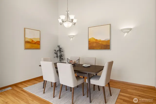 a kitchen with stainless steel appliances kitchen island wooden floors and white cabinets