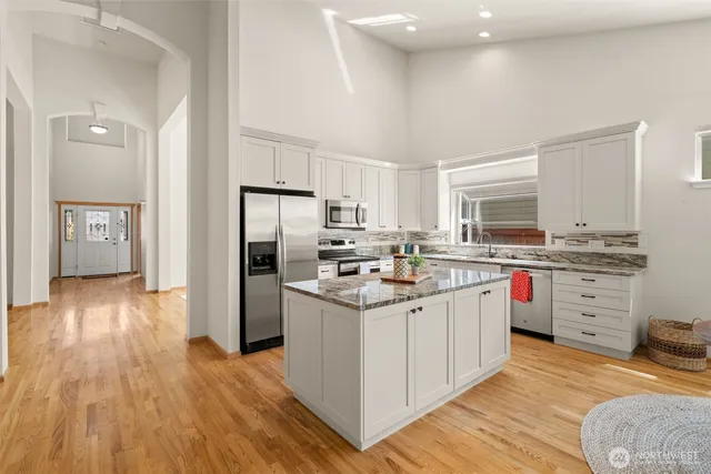 a kitchen with stainless steel appliances granite countertop a stove and a sink