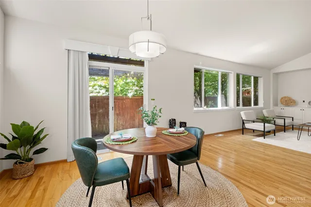 a view of a dining room with furniture and wooden floor