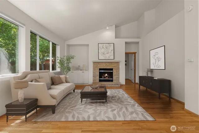 a living room with furniture fireplace and a large window
