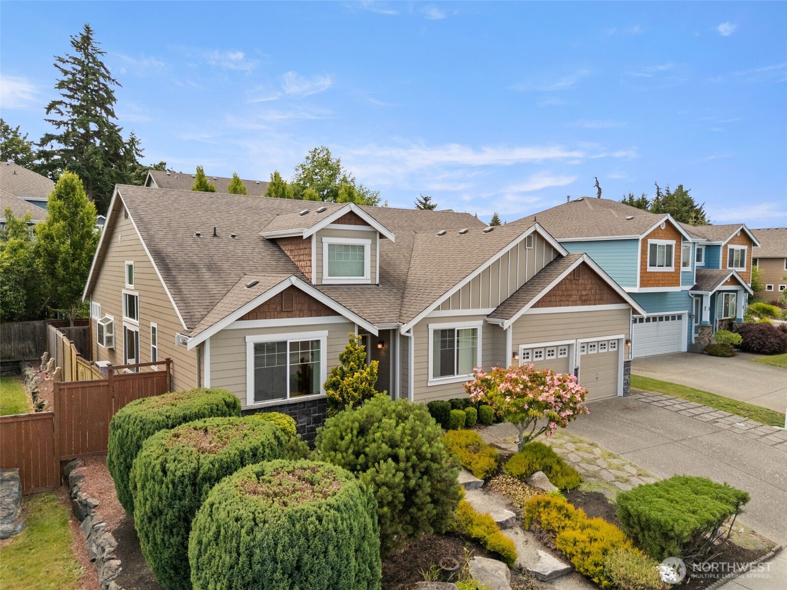 18130 Sunrise Ridge Avenue Northeast Poulsbo, WA 98370 - Photo 4 of 30 a front view of a house with a garden