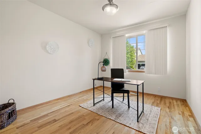a view of a workspace with furniture and wooden floor