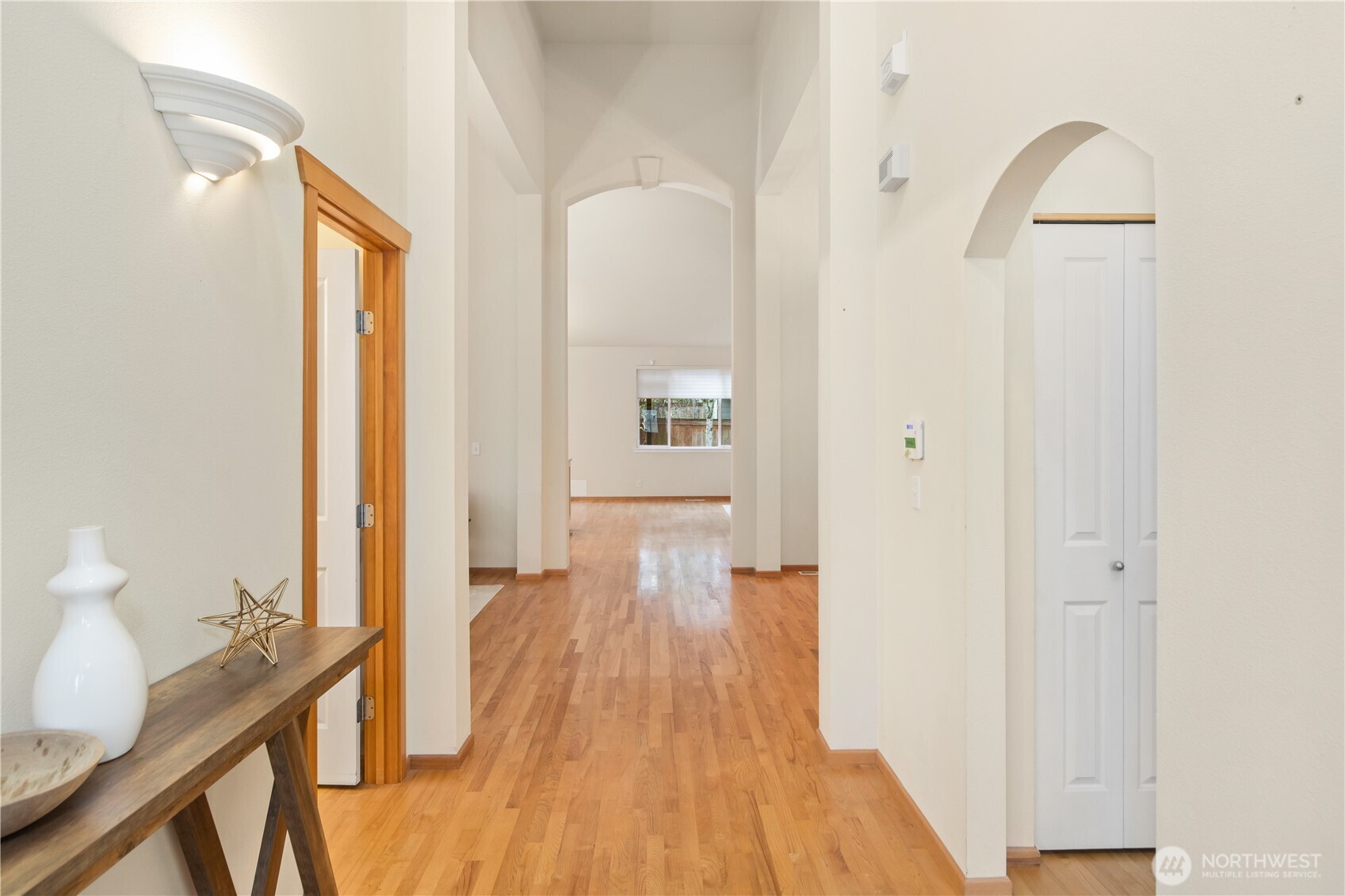 18130 Sunrise Ridge Avenue Northeast Poulsbo, WA 98370 - Photo 7 of 30 a view of a hallway with wooden floor and furniture