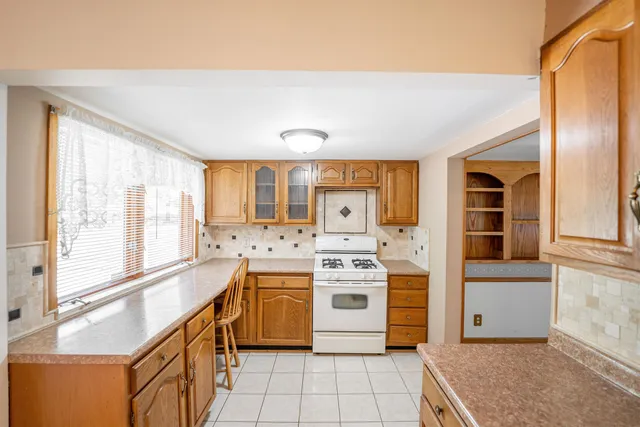 a view of a kitchen with stainless steel appliances granite countertop a refrigerator and a sink