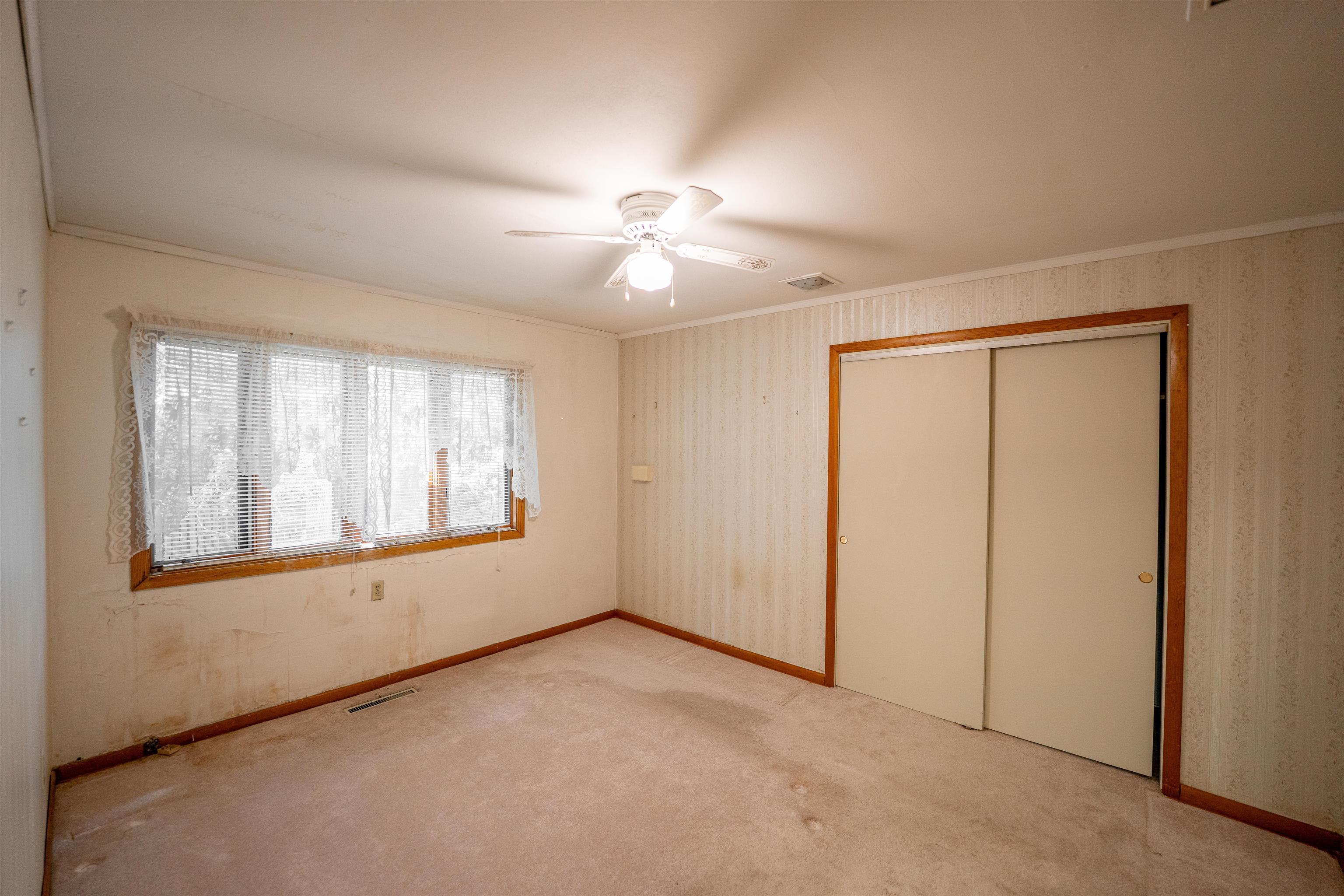 15361 South Bluff Road South Beloit, IL 61080 - Photo 27 of 64 an empty room with chandelier fan and windows