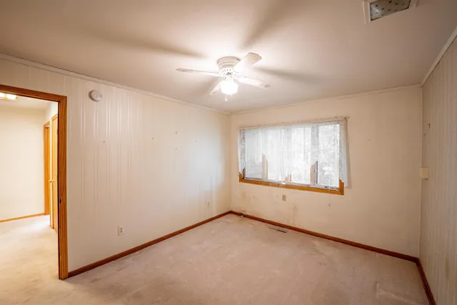 a view of an empty room with wooden furniture