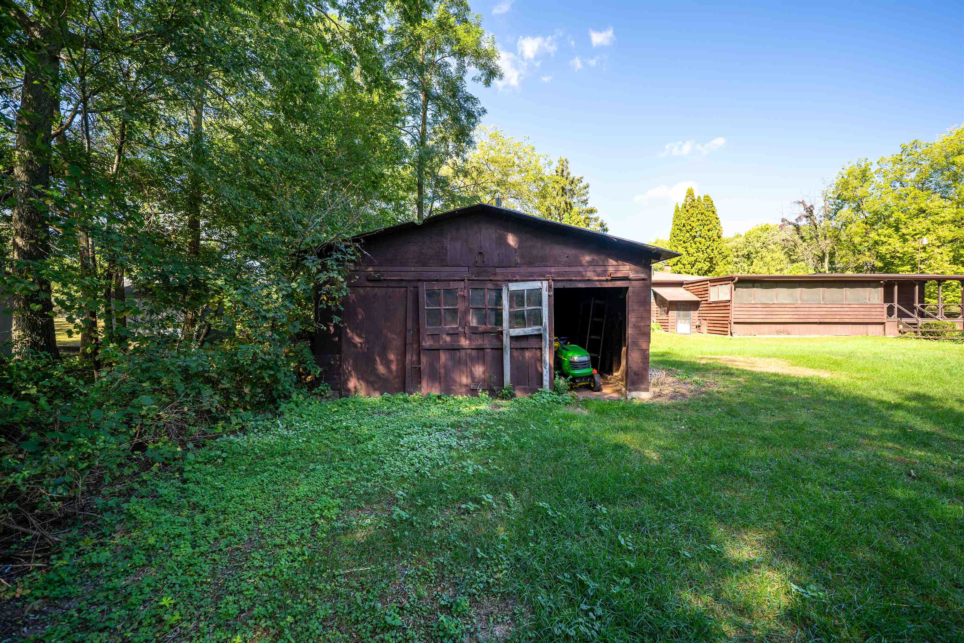 15361 South Bluff Road South Beloit, IL 61080 - Photo 43 of 64 a view of a garden with a fountain in a big yard
