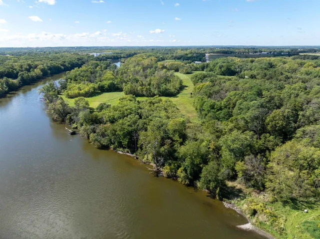 an aerial view of a house with a yard and lake view