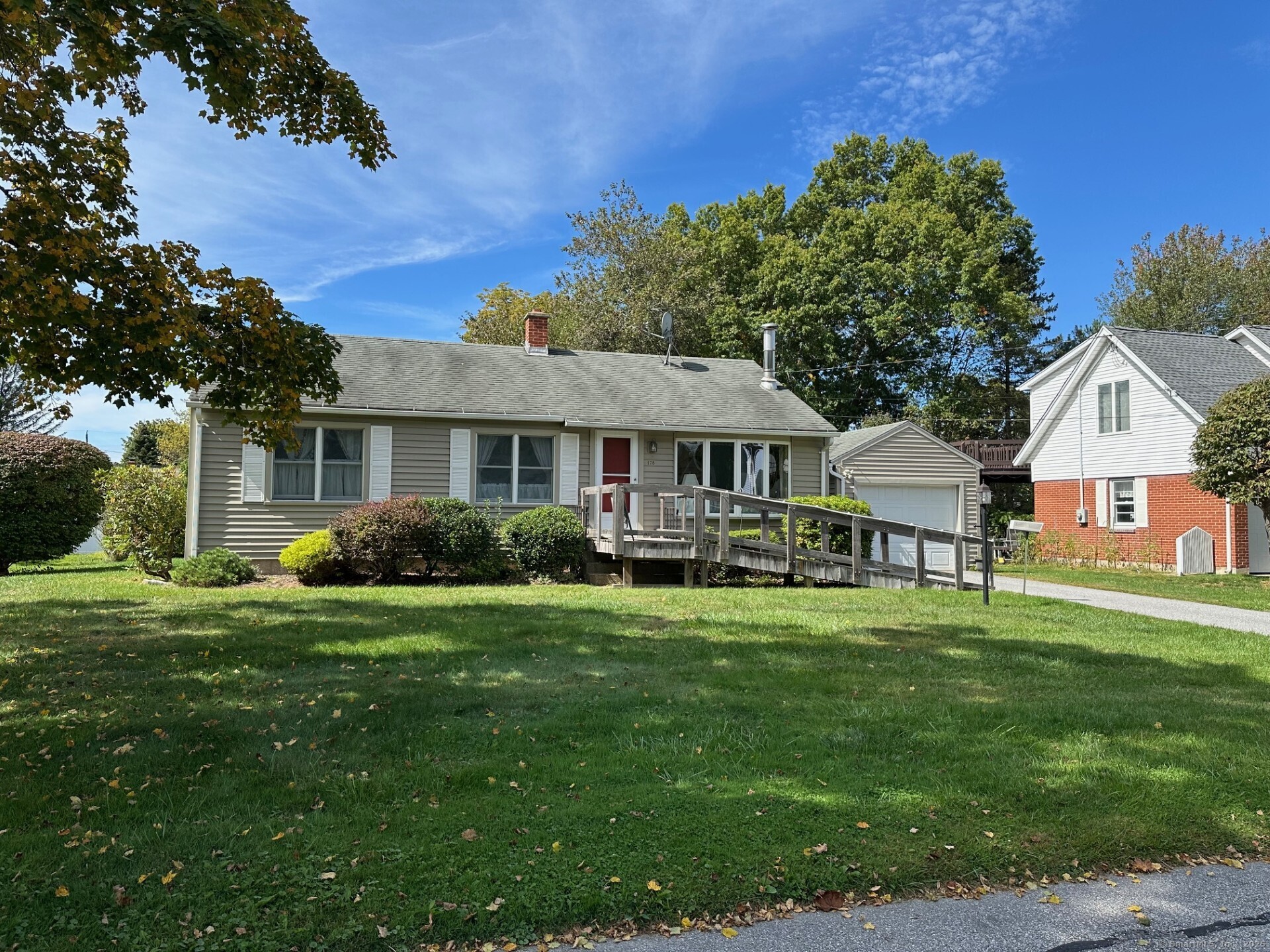 a front view of a house with a garden