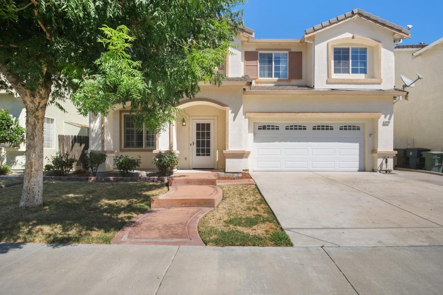3021 Simms Lane Tracy, CA 95377 - Photo 2 of 33 a front view of a house with a yard and garage