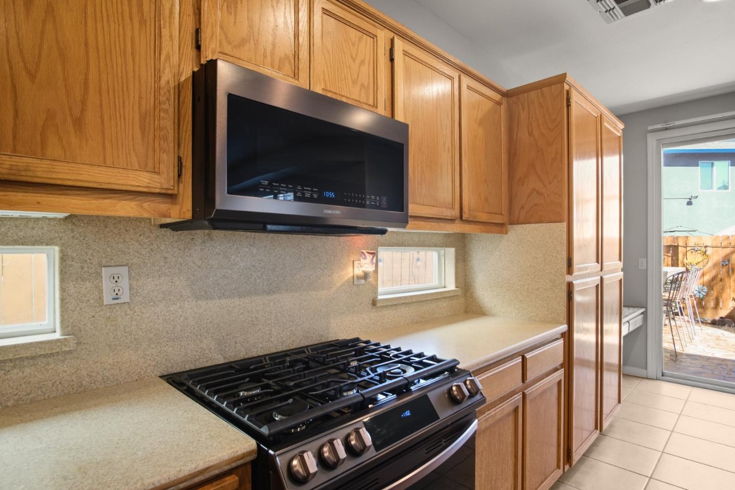 3021 Simms Lane Tracy, CA 95377 - Photo 22 of 33 a kitchen with stainless steel appliances a stove a microwave cabinets and a sink