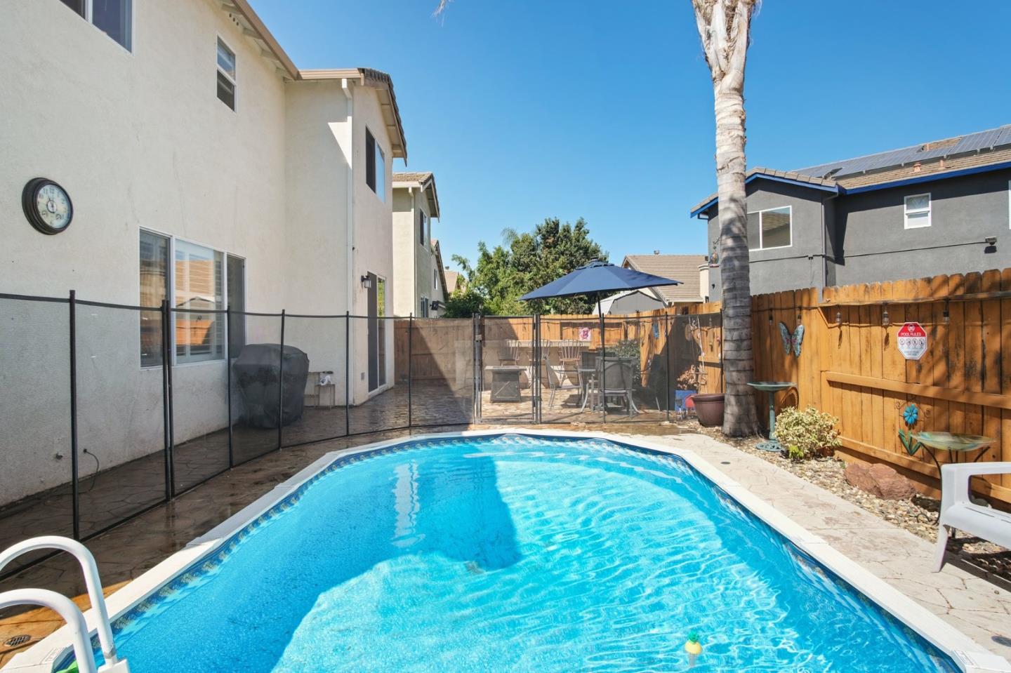 3021 Simms Lane Tracy, CA 95377 - Photo 25 of 33 a swimming pool with outdoor seating and yard