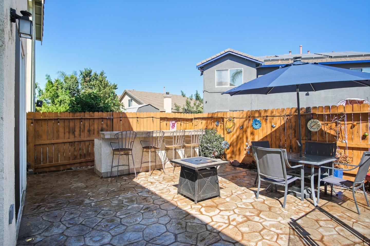 3021 Simms Lane Tracy, CA 95377 - Photo 27 of 33 a view of a patio with a table and chairs under an umbrella
