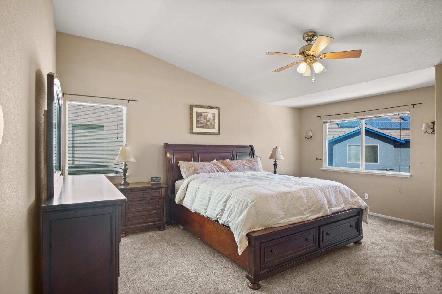 3021 Simms Lane Tracy, CA 95377 - Photo 9 of 33 a spacious bedroom with a bed and a chandelier
