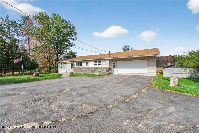 a front view of house with yard and green space