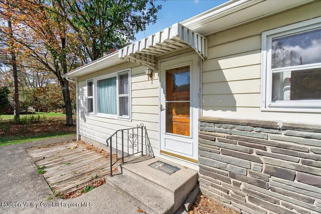 a view of a house with a yard and sitting area