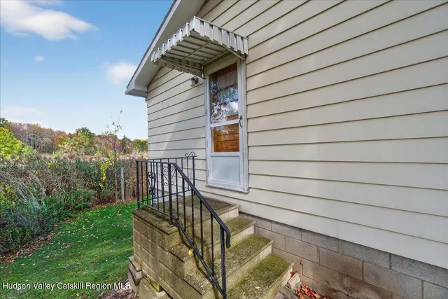 a view of backyard with deck and outdoor seating