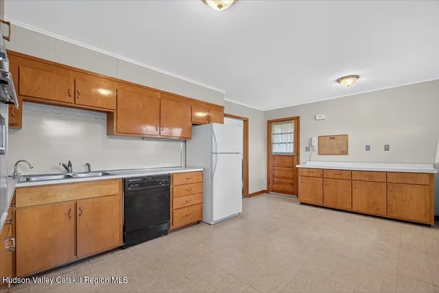 a kitchen with stainless steel appliances granite countertop a sink refrigerator and cabinets