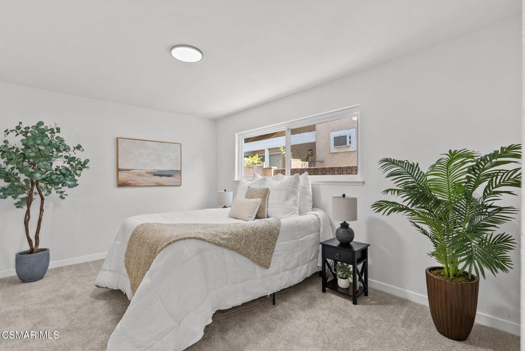 1882 Larch Street Simi Valley, CA 93065 - Photo 13 of 34 a bedroom with a bed and a potted plant
