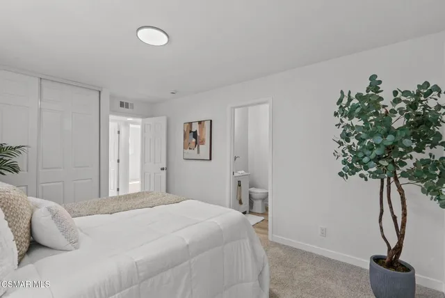 a bathroom with a sink mirror vanity and toilet