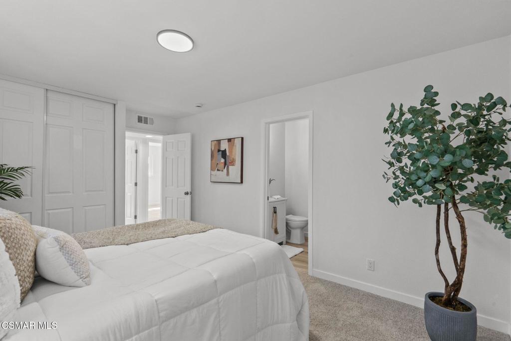 1882 Larch Street Simi Valley, CA 93065 - Photo 14 of 34 a bedroom with a bed and a potted plant