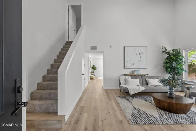 a living room with furniture potted plant and window