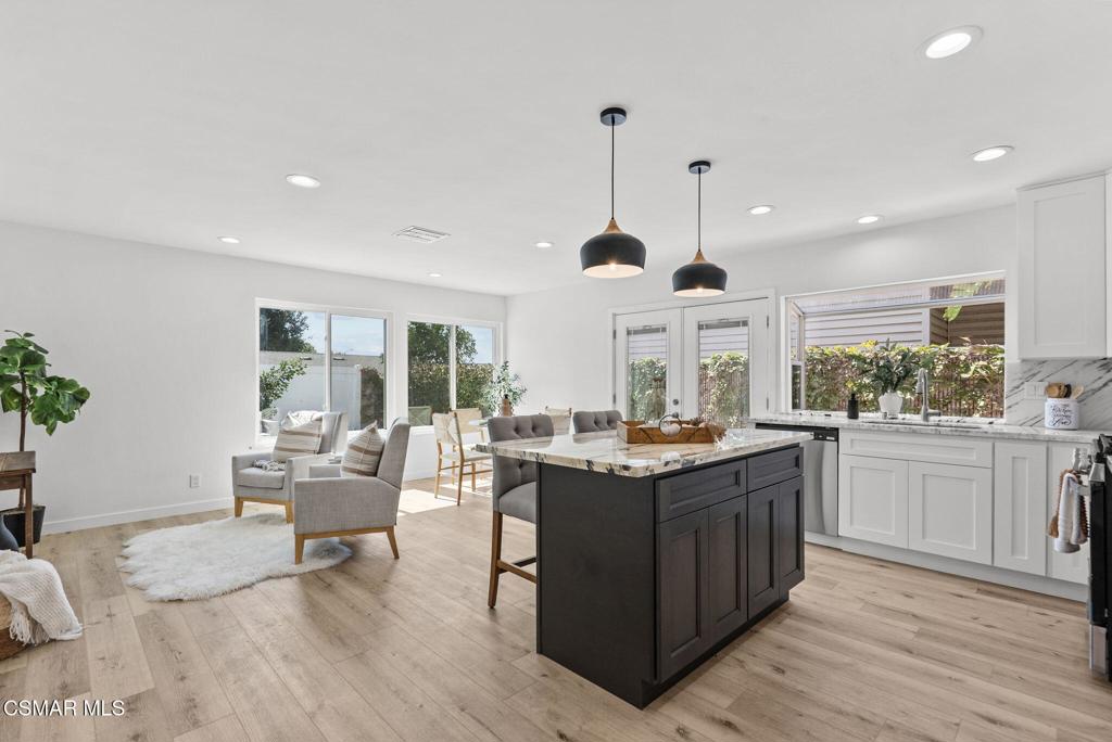 1882 Larch Street Simi Valley, CA 93065 - Photo 10 of 34 a view of a kitchen with kitchen island granite countertop wooden floor stainless steel appliances and dining table