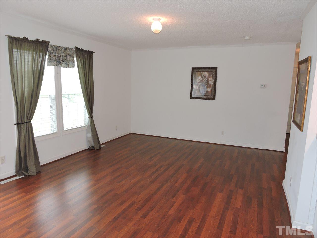 320 Moriah Road Rougemont, NC 27572 - Photo 3 of 16 an empty room with wooden floor and windows
