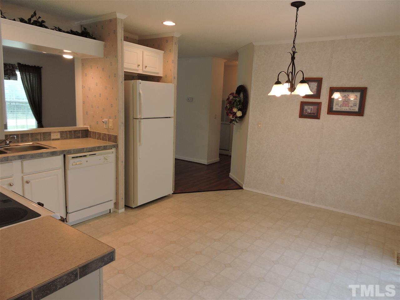 320 Moriah Road Rougemont, NC 27572 - Photo 4 of 16 a kitchen with stainless steel appliances kitchen island granite countertop a refrigerator a stove and a sink
