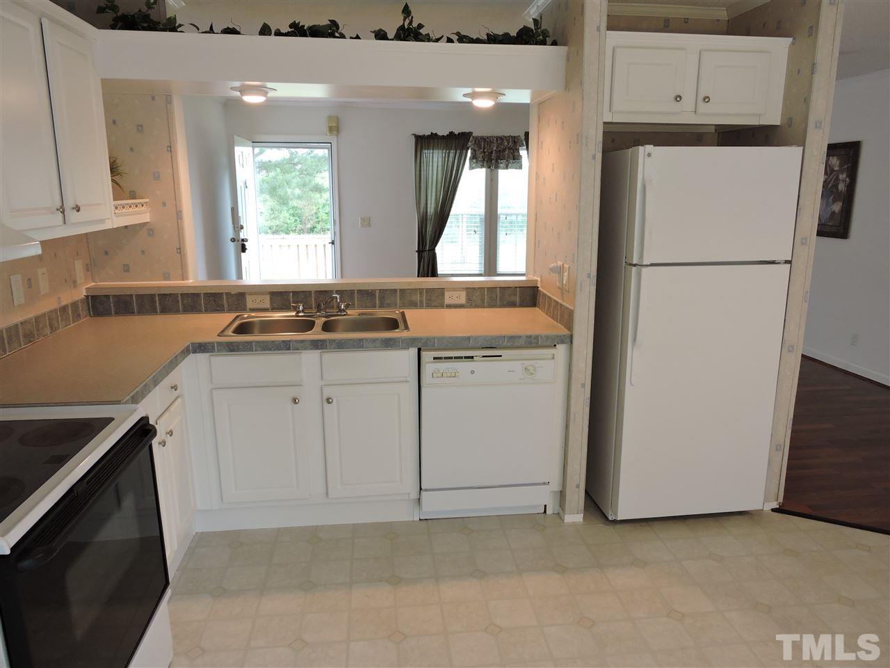 320 Moriah Road Rougemont, NC 27572 - Photo 5 of 16 a kitchen with granite countertop white cabinets and refrigerator