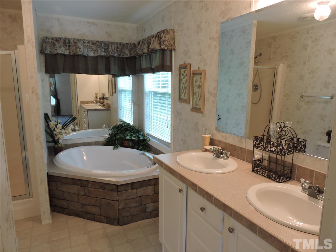 320 Moriah Road Rougemont, NC 27572 - Photo 10 of 16 a bathroom with a double vanity sink and a mirror