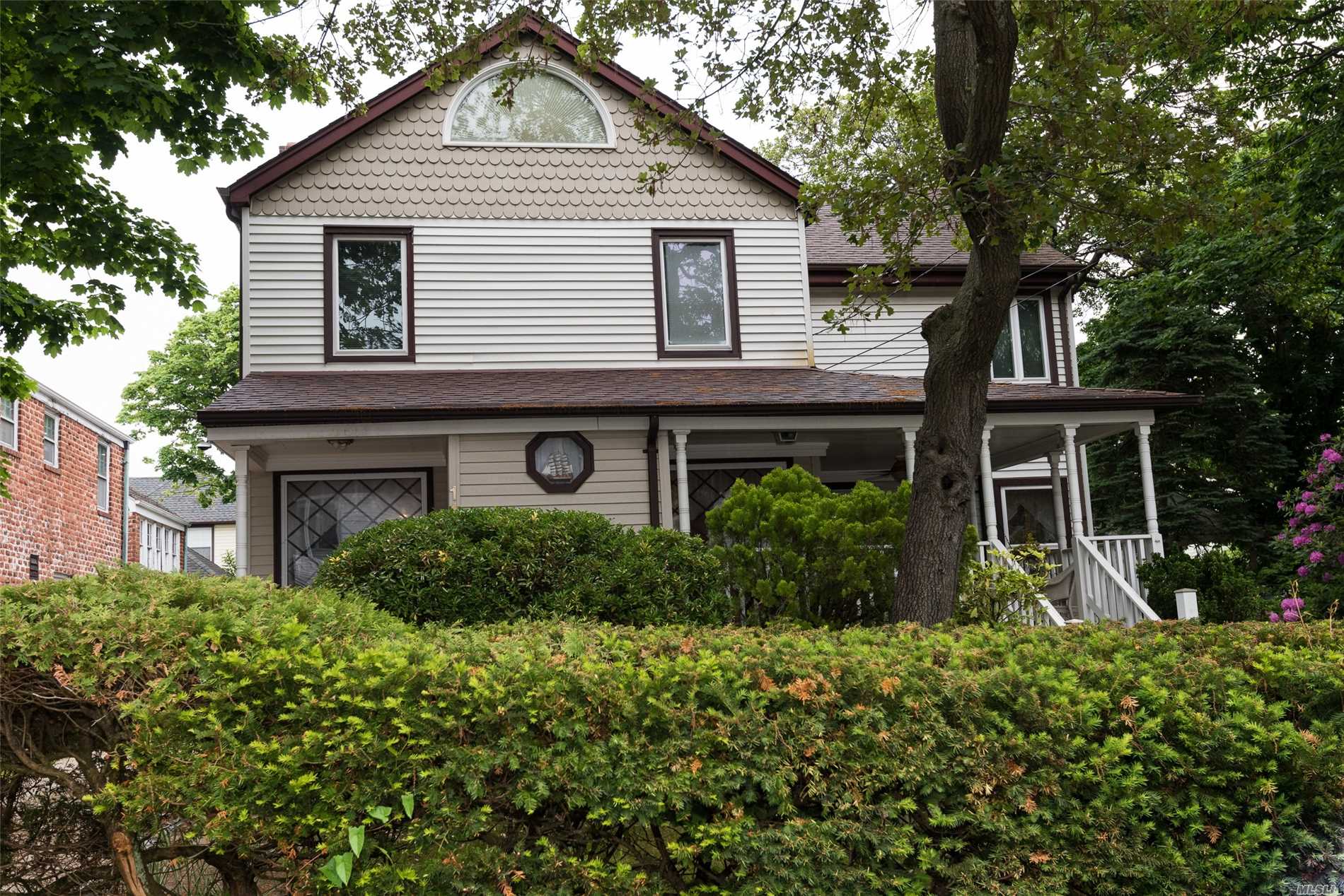 a front view of house with a garden