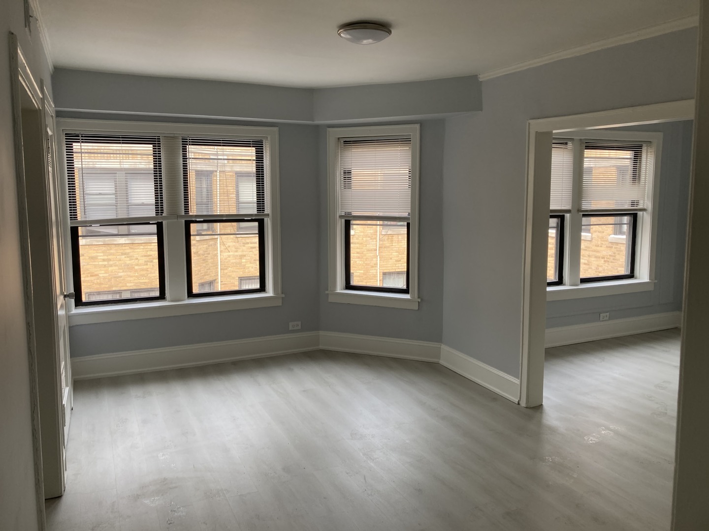 7325 North Honore Street, Unit 3B Chicago, IL 60626 - Photo 2 of 10 an empty room with windows