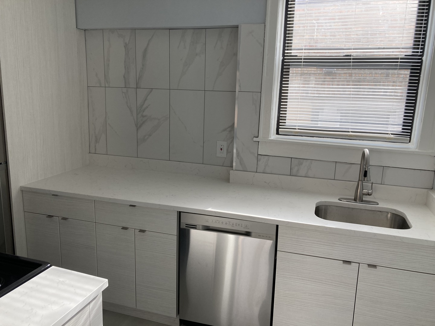 7325 North Honore Street, Unit 3B Chicago, IL 60626 - Photo 7 of 10 a kitchen with a sink and a window