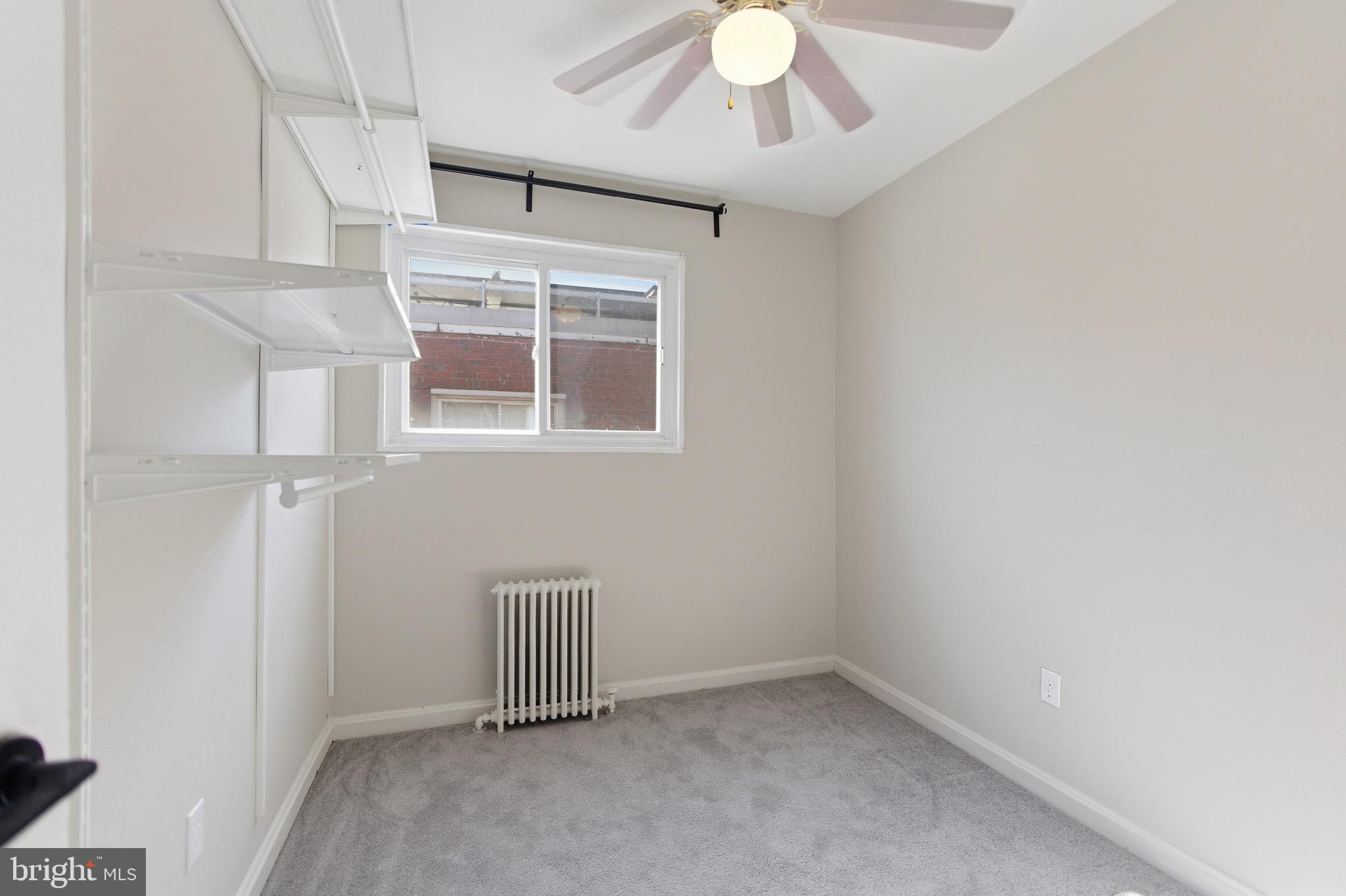 7519 8th Street Northwest Washington, DC 20012 - Photo 11 of 19 an empty room with a ceiling fan and a window