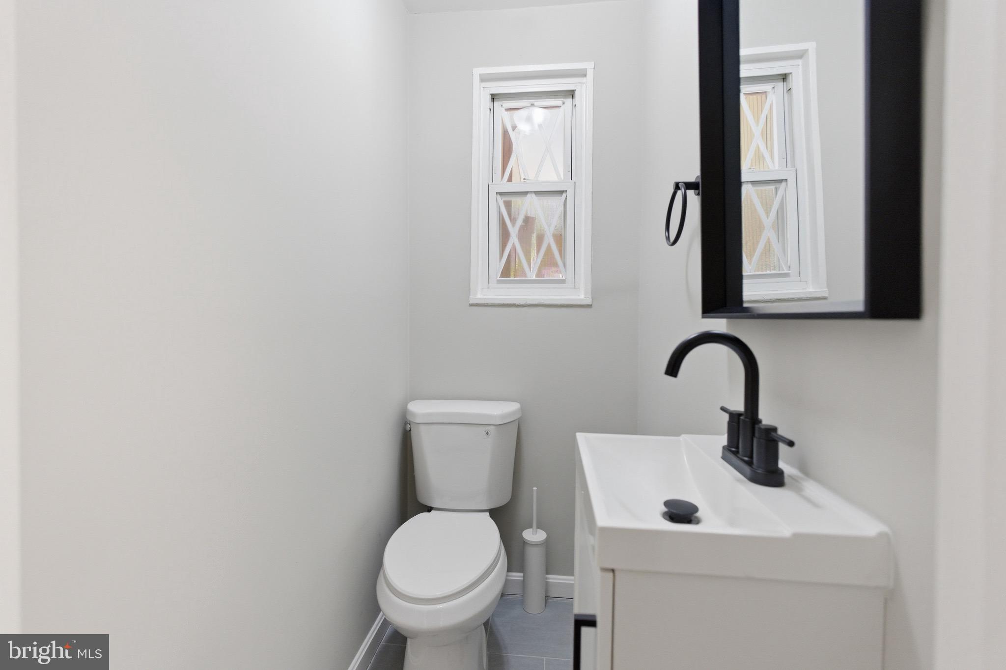 7519 8th Street Northwest Washington, DC 20012 - Photo 15 of 19 a bathroom with a toilet sink and mirror