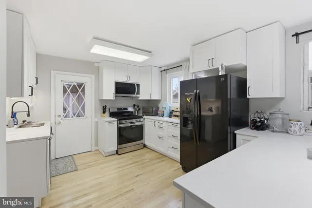 a kitchen with a refrigerator stove and sink