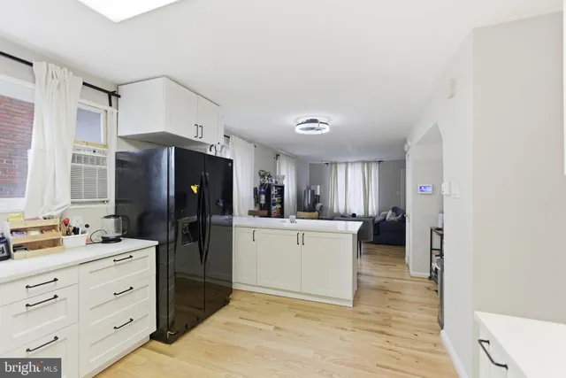 a kitchen with a refrigerator and a sink