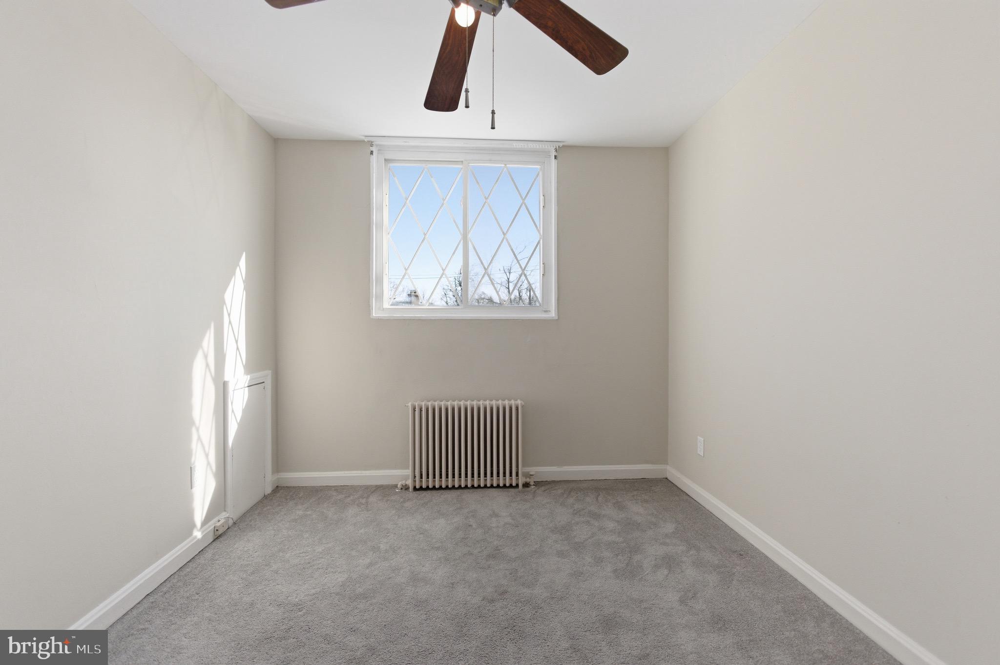7519 8th Street Northwest Washington, DC 20012 - Photo 9 of 19 an empty room with ceiling fan and window