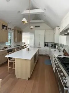 a kitchen with stainless steel appliances a sink stove and cabinets