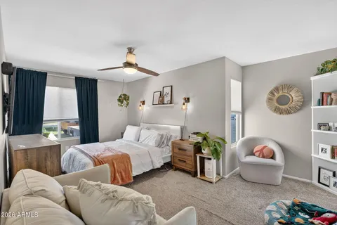 a bedroom with a bed mirror and window