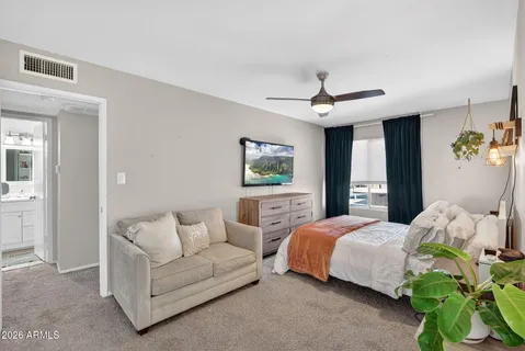 a bedroom with furniture and a flat screen tv