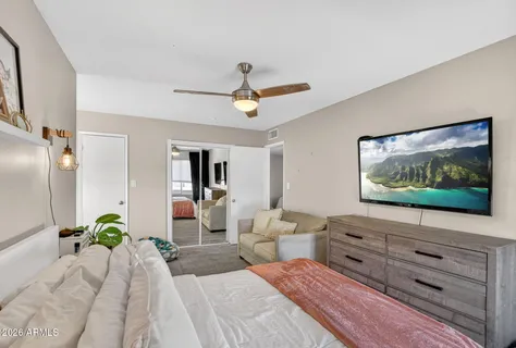 a bedroom with a large bed and a chandelier