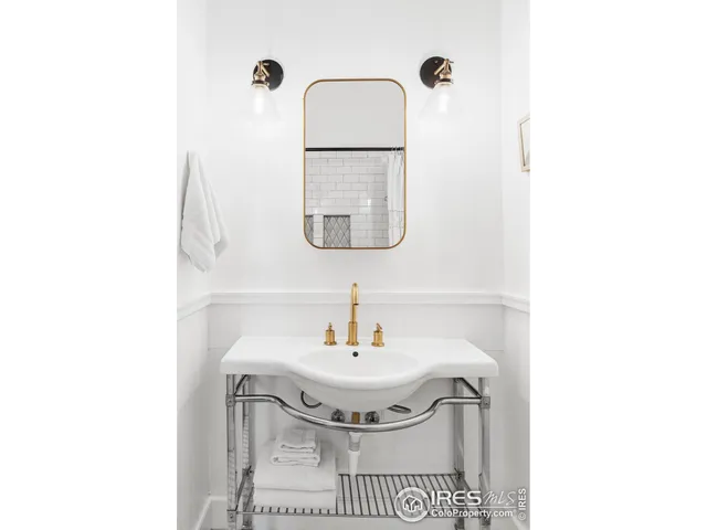 a bathroom with a sink a mirror and vanity