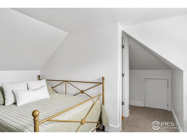 a view of a bedroom with a bed and dresser