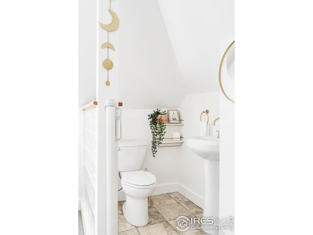 a bathroom with a toilet and a mirror
